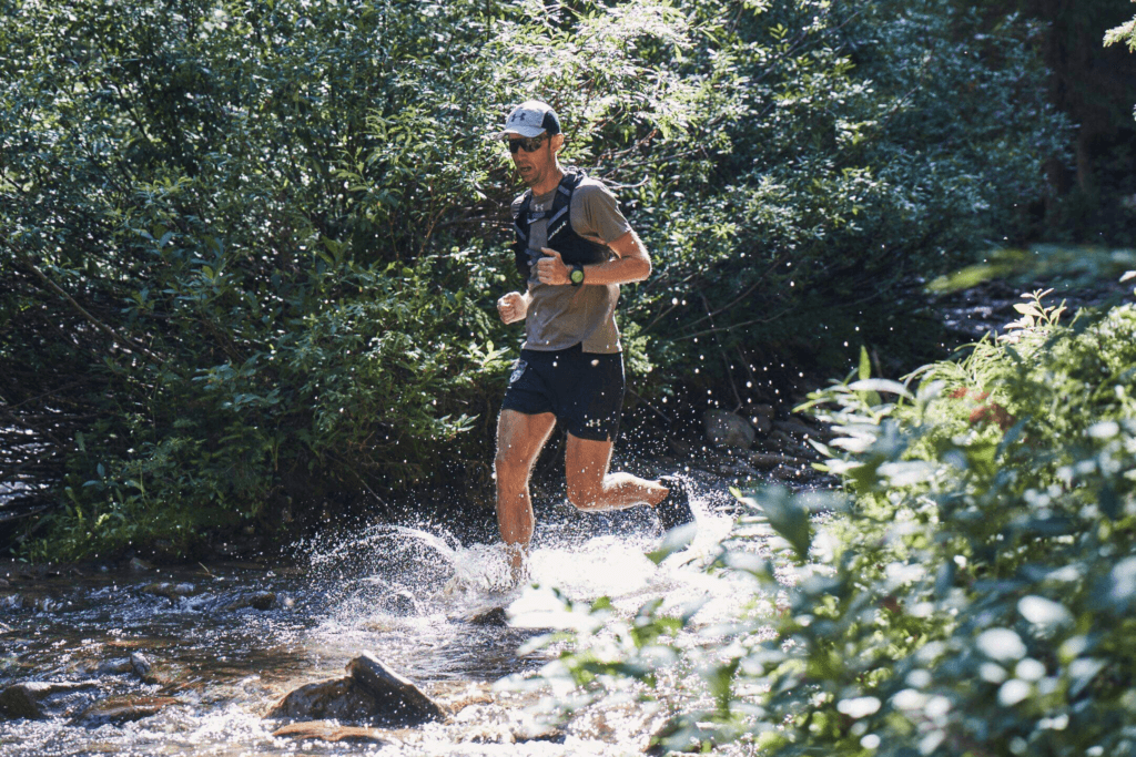 Runner running through stream 