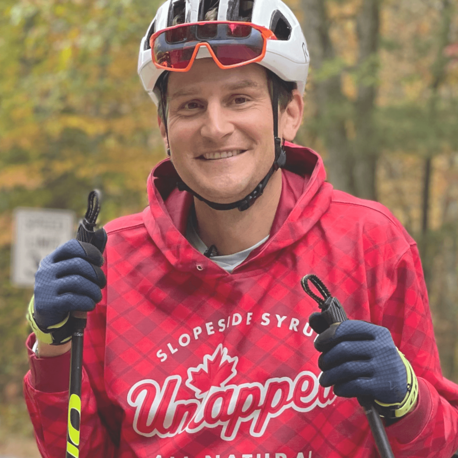 Ted King in a bike helmet and holding ski poles